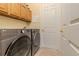 Laundry room features a modern LG washer and dryer set with functional upper cabinetry at 537 Montage Ln, Kissimmee, FL 34759