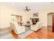 Bright open concept living room featuring modern furniture, a ceiling fan, and wood flooring at 537 Montage Ln, Kissimmee, FL 34759