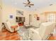 Spacious living room featuring hardwood floors, plush seating, and a ceiling fan for added comfort at 537 Montage Ln, Kissimmee, FL 34759