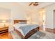 Comfortable main bedroom with fan, trey ceilings, and hardwood floors with access to the bathroom at 537 Montage Ln, Kissimmee, FL 34759
