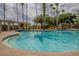 Outdoor pool with palm trees and lounge chairs, perfect for relaxation and enjoying the sunny weather at 537 Montage Ln, Kissimmee, FL 34759