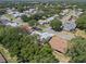 An elevated view shows home nestled in a sprawling neighborhood with many mature trees and winding streets at 5712 Connors St, Leesburg, FL 34748