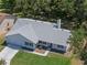 Aerial view of a beautiful home showcasing its well-maintained landscaping, roof, and surrounding neighborhood at 5712 Connors St, Leesburg, FL 34748