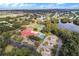 Aerial view featuring community amenities including a clubhouse, pool and tennis courts at 5712 Connors St, Leesburg, FL 34748