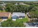 High-angle view of a single-Gathering home, showing its roof, landscaping, and the surrounding wooded area at 5712 Connors St, Leesburg, FL 34748