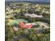 Aerial view showcasing community amenities including clubhouse, pool, and tennis courts at 5712 Connors St, Leesburg, FL 34748