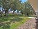 Expansive backyard featuring lush green grass, mature trees, and plenty of room for outdoor activities and entertaining at 5712 Connors St, Leesburg, FL 34748