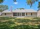 Well-maintained backyard with a screened-in lanai, perfect for enjoying the outdoors in comfort and style at 5712 Connors St, Leesburg, FL 34748