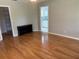 Bedroom featuring hardwood floors, closet and natural light from a window to the attached bathroom at 5712 Connors St, Leesburg, FL 34748