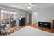 Bedroom showing hardwood floors, a ceiling fan, access to a screened-in lanai at 5712 Connors St, Leesburg, FL 34748