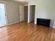 Bedroom with hardwood floors, open closet space, and sliding door access to the outside at 5712 Connors St, Leesburg, FL 34748
