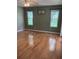 Bedroom with hardwood flooring and two large windows offering plenty of natural light at 5712 Connors St, Leesburg, FL 34748