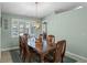 Elegant dining room with plantation shutters, stylish chandelier, and hardwood table at 5712 Connors St, Leesburg, FL 34748
