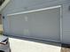 Garage features a grey, roll-down mesh door providing privacy at 5712 Connors St, Leesburg, FL 34748