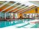 Bright indoor pool with a skylight ceiling and clear glass windows at 5712 Connors St, Leesburg, FL 34748