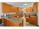 Spacious kitchen features granite countertops, stainless steel refrigerator, and custom wood cabinetry at 5712 Connors St, Leesburg, FL 34748