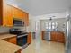 Well-equipped kitchen with stainless steel appliances, granite countertops and ample cabinetry at 5712 Connors St, Leesburg, FL 34748