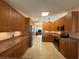 Well-lit kitchen offers stainless steel appliances, granite countertops, and classic wood cabinets at 5712 Connors St, Leesburg, FL 34748