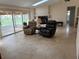 Bright living room featuring tile floors, a ceiling fan, sliding glass doors and a fireplace at 5712 Connors St, Leesburg, FL 34748