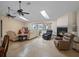 Bright living room featuring a fireplace, comfortable seating, skylights, and a sliding glass door at 5712 Connors St, Leesburg, FL 34748
