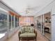 Relaxing sunroom showcasing comfortable seating, neutral decor, and panoramic views of the surrounding landscape at 5712 Connors St, Leesburg, FL 34748