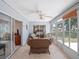 Inviting sunroom with wicker furniture, tile flooring, and ample natural light streaming through the windows at 5712 Connors St, Leesburg, FL 34748