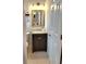 Stylish bathroom features a wooden vanity, updated mirror, and neutral paint at 607 Baldwin Dr, Kissimmee, FL 34758