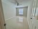 This bedroom features a ceiling fan and glossy tile floors at 607 Baldwin Dr, Kissimmee, FL 34758