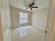 Bedroom with tile floors, a ceiling fan, a window, and neutral walls at 607 Baldwin Dr, Kissimmee, FL 34758
