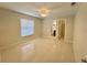 Bright bedroom with tile flooring, ceiling fan, and an attached bathroom and closet at 607 Baldwin Dr, Kissimmee, FL 34758