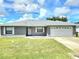 Charming single-story home with a well-manicured lawn and a two-car garage at 607 Baldwin Dr, Kissimmee, FL 34758