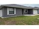 Charming single-story home with gray exterior, white trim, and landscaped front yard at 607 Baldwin Dr, Kissimmee, FL 34758