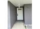 The white front door of home, located in a recessed area, with side landscaping at 607 Baldwin Dr, Kissimmee, FL 34758
