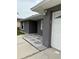 Home's front entrance featuring a white front door and stone landscaping at 607 Baldwin Dr, Kissimmee, FL 34758