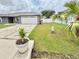 Home with well maintained yard, 2 car garage, and palm trees at 607 Baldwin Dr, Kissimmee, FL 34758