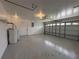 Spacious garage with painted floor and access door to the house at 607 Baldwin Dr, Kissimmee, FL 34758