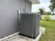 HVAC unit on a concrete slab with landscaping and white decorative rock at 607 Baldwin Dr, Kissimmee, FL 34758
