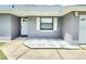 Exterior view of home with clean gray paint, white trim and hardscaped walkway at 607 Baldwin Dr, Kissimmee, FL 34758