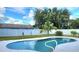 A beautiful backyard pool surrounded by a white fence and lush greenery at 607 Baldwin Dr, Kissimmee, FL 34758