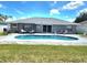 Beautiful backyard with a swimming pool, patio area, and lush green grass at 607 Baldwin Dr, Kissimmee, FL 34758