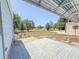 A brick-paved patio is surrounded by a lush green lawn, creating an inviting outdoor living space at 608 Saint Andrews Blvd, Lady Lake, FL 32159