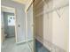 Bathroom with mirrored closet and decorative window at 608 Saint Andrews Blvd, Lady Lake, FL 32159