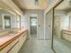 En-suite bathroom with dual vanity and large mirror at 608 Saint Andrews Blvd, Lady Lake, FL 32159