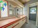 Bathroom with vanity and decorative windows at 608 Saint Andrews Blvd, Lady Lake, FL 32159