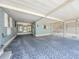A spacious carport providing covered parking and access to sunroom and a latticed patio at 608 Saint Andrews Blvd, Lady Lake, FL 32159