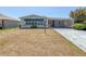 Charming single-story home with covered parking and well-maintained front yard at 608 Saint Andrews Blvd, Lady Lake, FL 32159