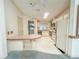 Bright kitchen features skylight, white cabinets, and functional layout at 608 Saint Andrews Blvd, Lady Lake, FL 32159