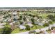 Gorgeous aerial view of a neighborhood showcasing manicured lawns, mature trees, and a scenic golf course with tranquil ponds at 616 Hartford Ln, The Villages, FL 32162