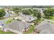 Aerial view of the home, showcasing lush landscaping, a private backyard, and a screened-in lanai at 616 Hartford Ln, The Villages, FL 32162
