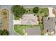Aerial view of a well manicured home with beautiful landscaping in a tranquil residential neighborhood at 616 Hartford Ln, The Villages, FL 32162